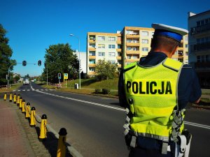 Policjant kontroluje prędkość w rejonie przejścia dla pieszych.