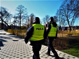 Policjanci sprawdzają plac zabaw pod kątem grupowania się osób.